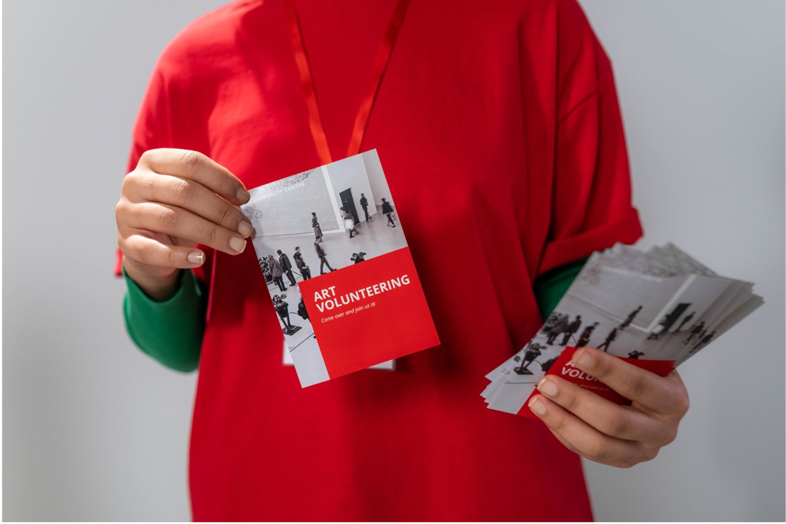 A woman holding flyers A woman handing out traditional marketing flyers.