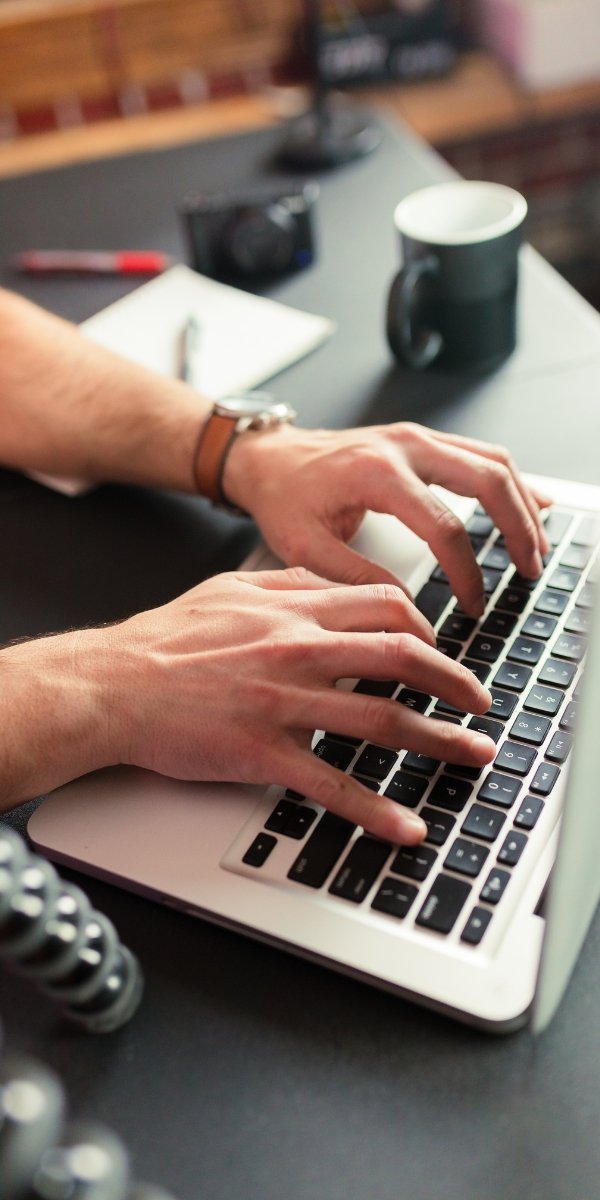 Person writing on laptop