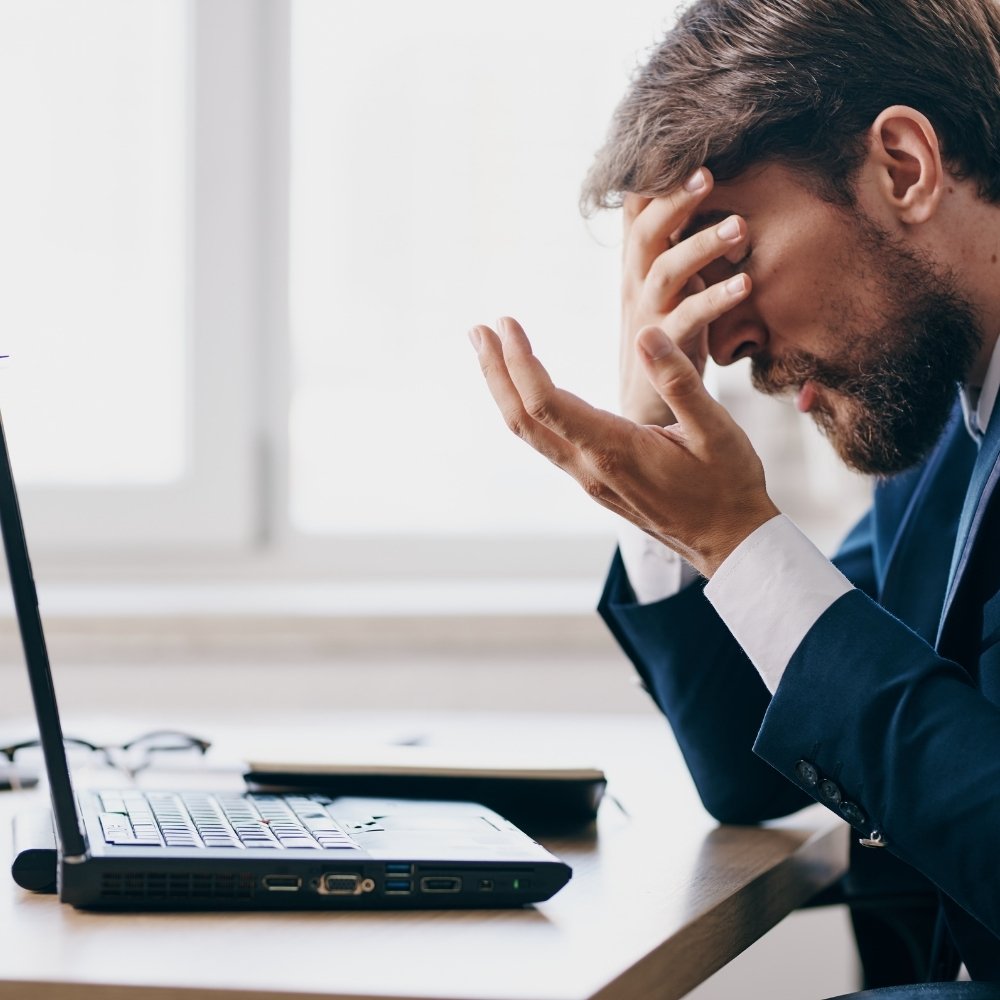 Frustrated business owner struggling with outdated processes in the office.