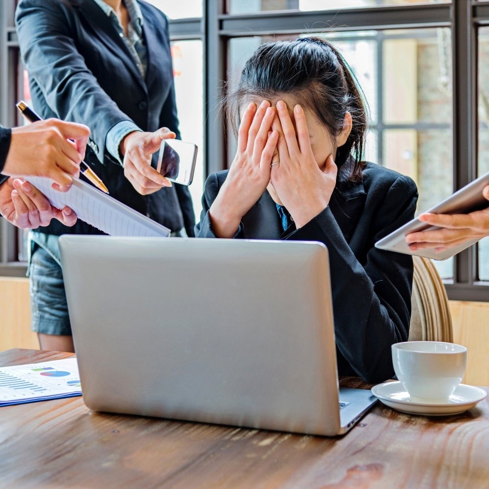 Too many tasks Overwhelmed small business owner buried in paperwork and admin tasks, highlighting the struggles of manual internal operations